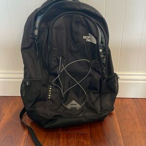 The North Face Jester black backpack. Has lots of pockets and spot for laptop.